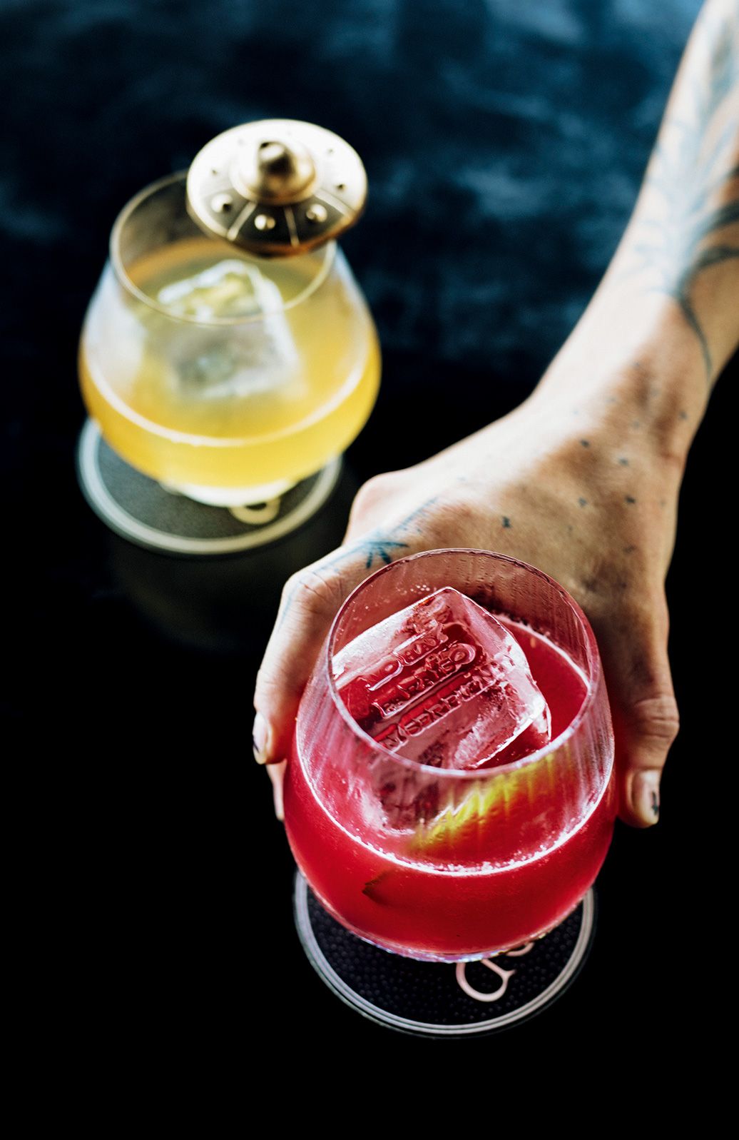 An innovative dessert presentation featuring smoke effects and creamy textures in a specialized glass vessel.