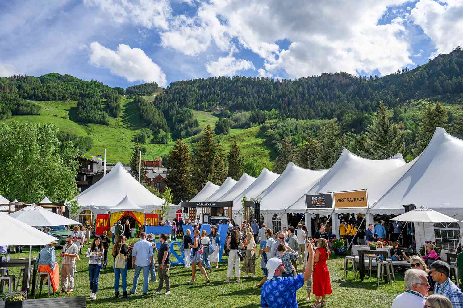 A celebrity chef lead a cooking demonstration for a group of enthusiasts at the Aspen Food and Wine Classic.