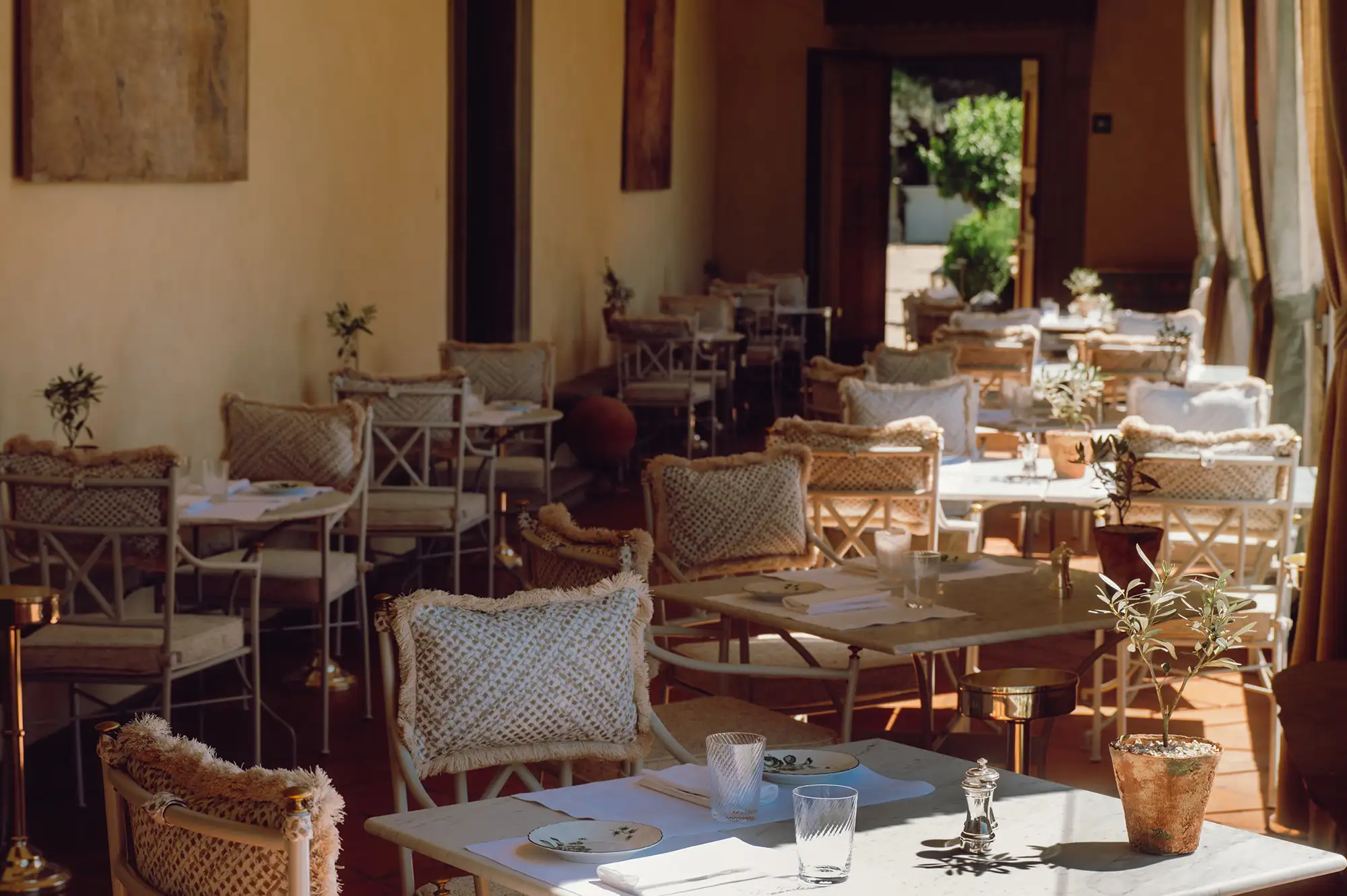 Outdoor dining setup at Villa San Michele with rustic furniture and valley views.