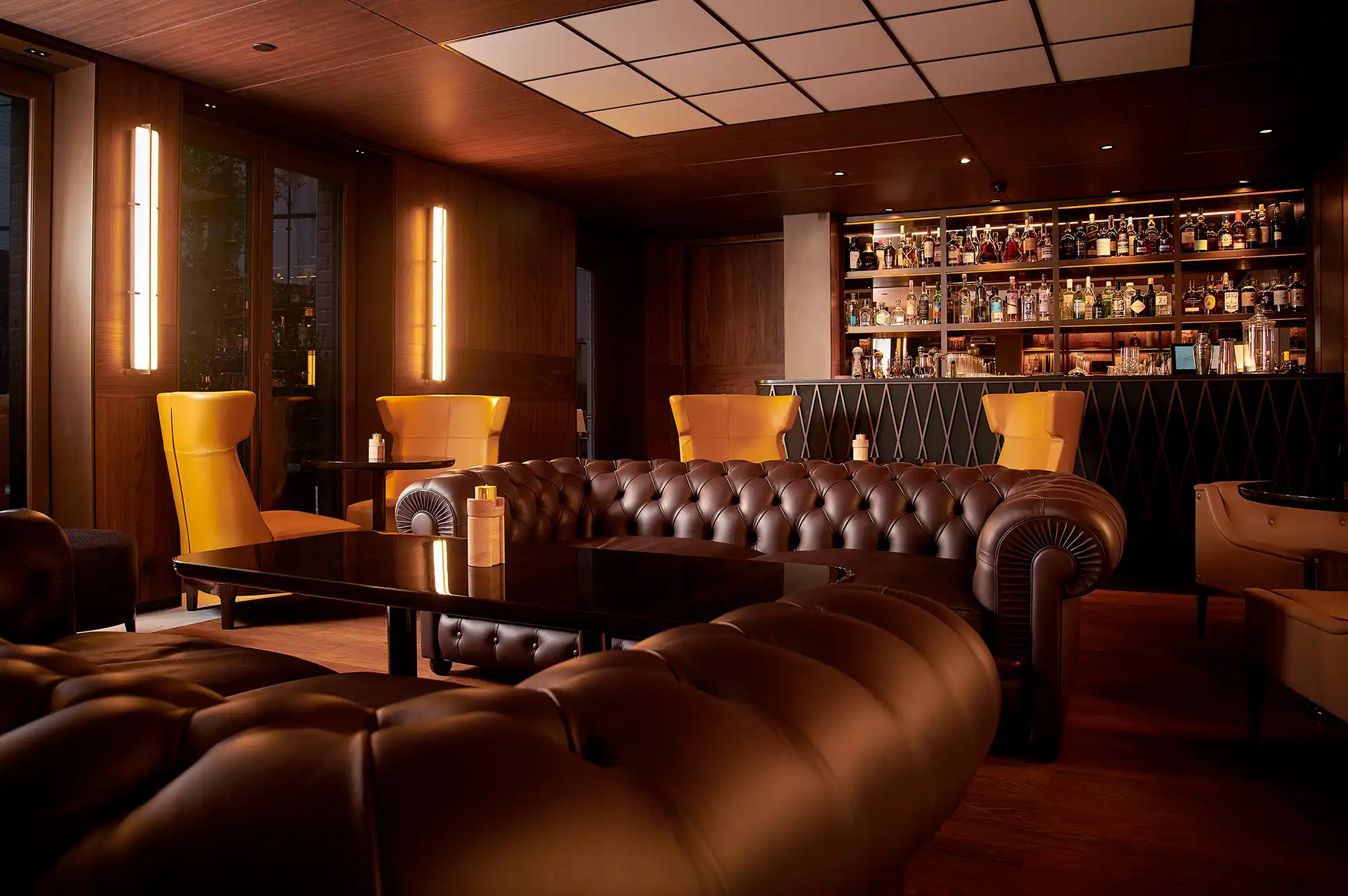 A contemporary bar area with leather seating and stylish lighting at Mandarin Oriental Lutetia.