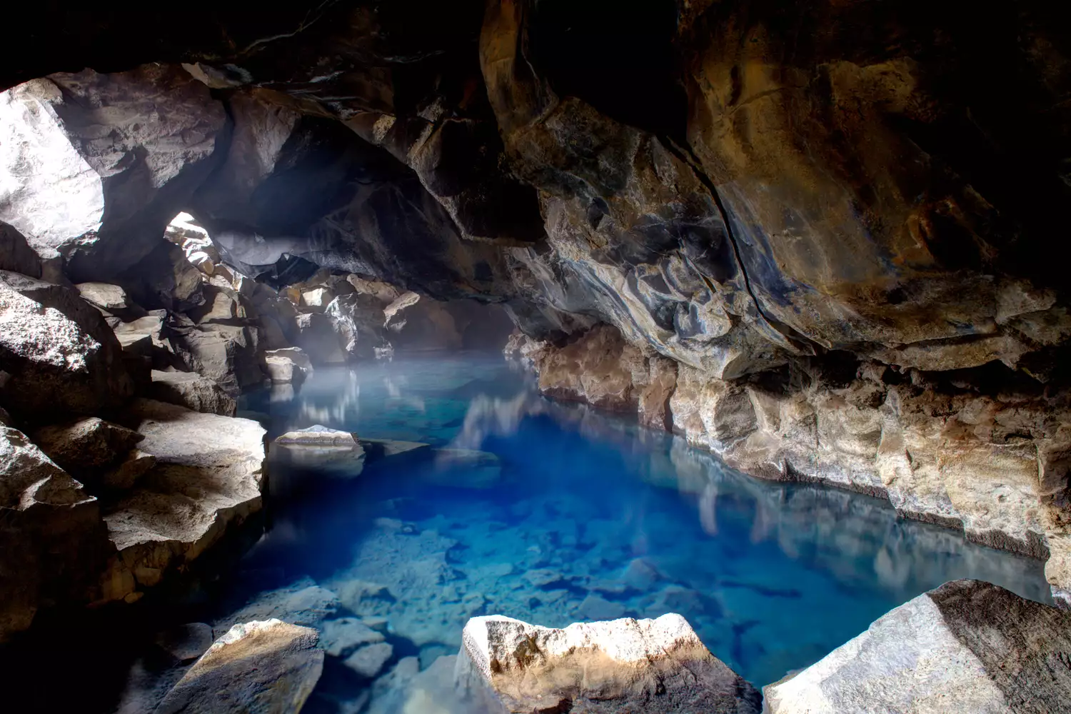Blue thermal water inside the Grjótagjá lava cave near Lake Mývatn.