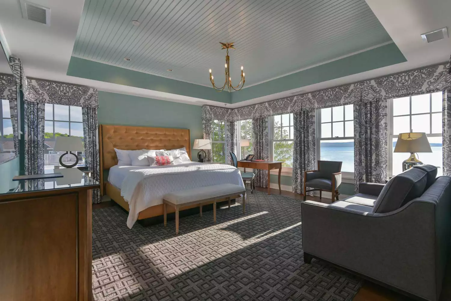 A spacious and elegantly decorated guest suite at Hotel Walloon with subtle nautical accents.