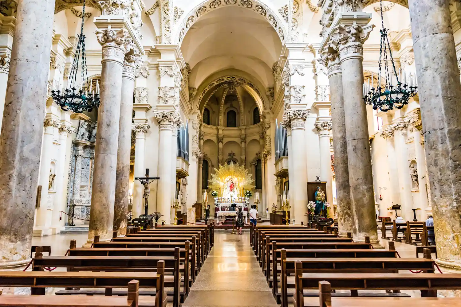 The ornate stone interior and ceiling of the Basilica di Santa Croce in Lecce.