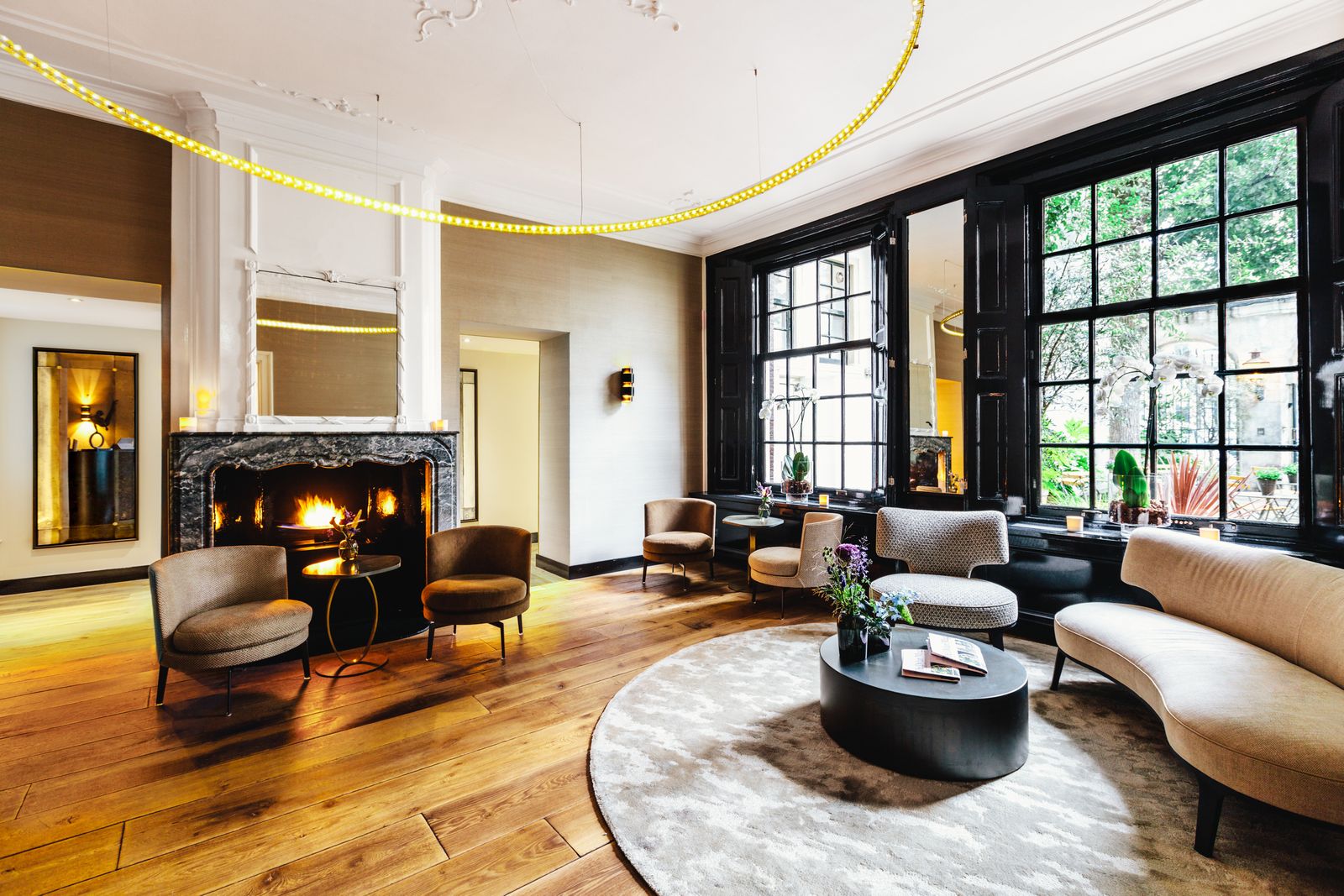 Modern and elegant interior of a luxury hotel lobby with a seating area.