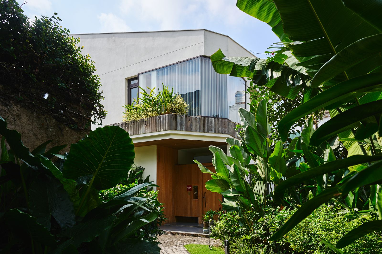 A luxury balcony view of a residential villa surrounded by lush greenery in Thao Dien.