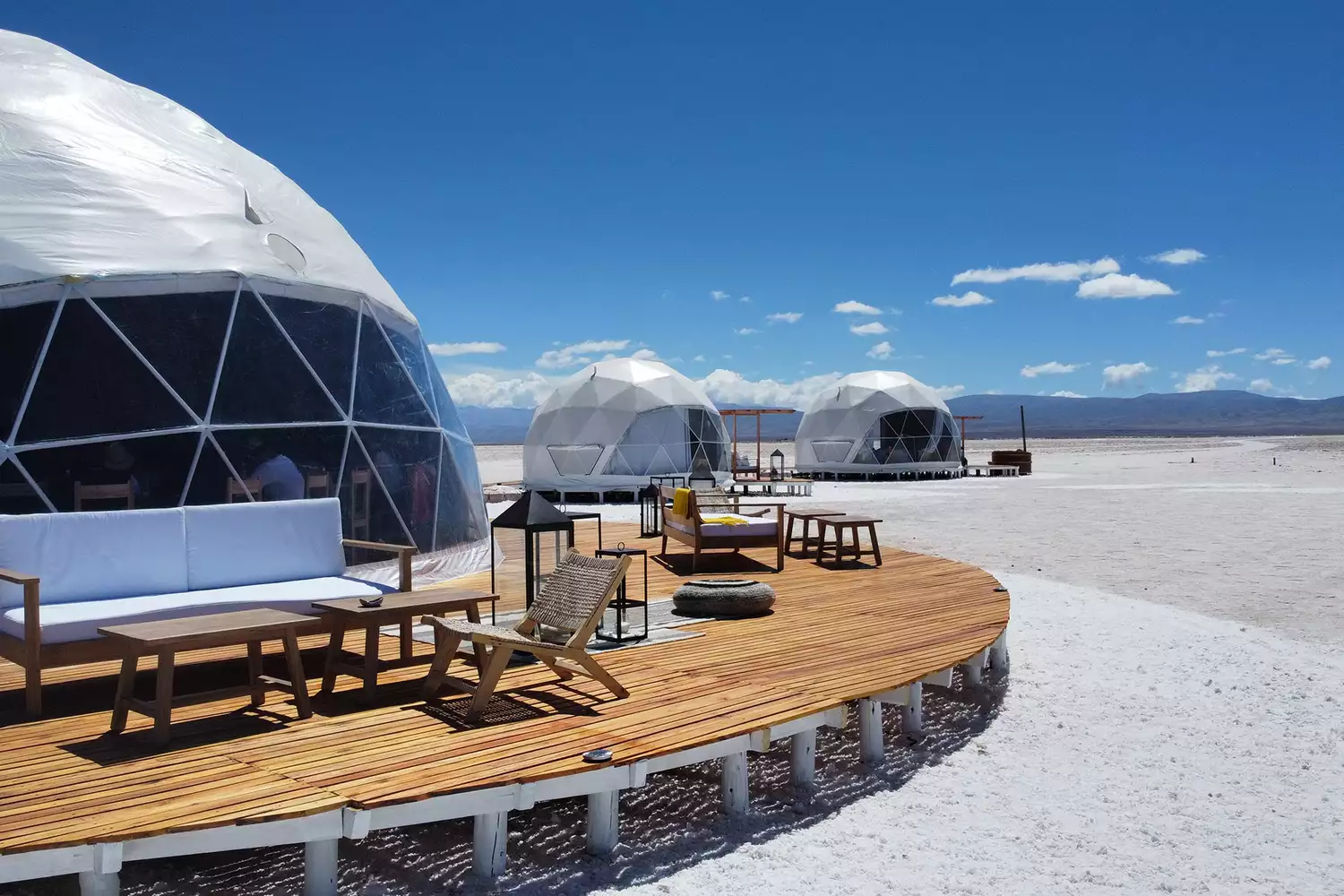 Exterior of Pristine Camps domes situated on a vast, high-altitude salt flat in Argentina.