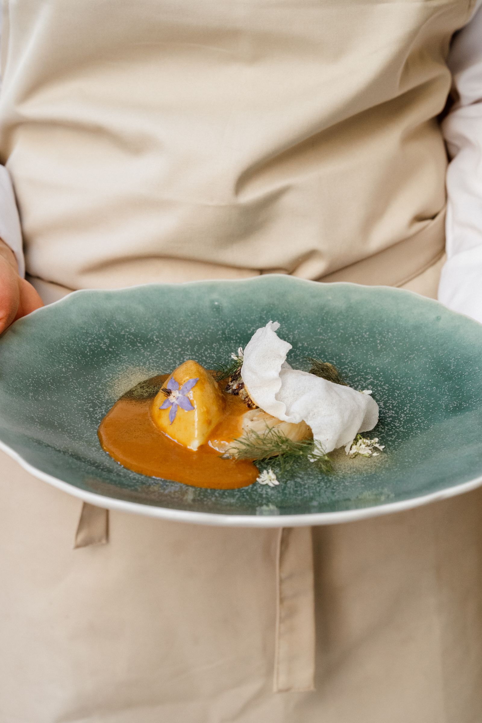 A close-up of a perfectly poached egg dish served in a traditional Lyonnais style.