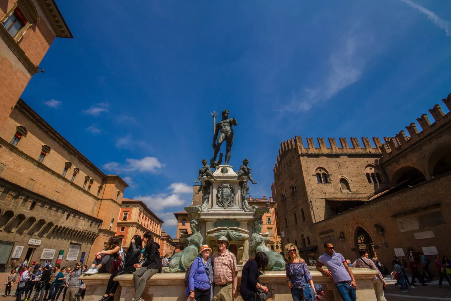 Crowds of people gathered around the bronze Statue of Neptune in the city center.
