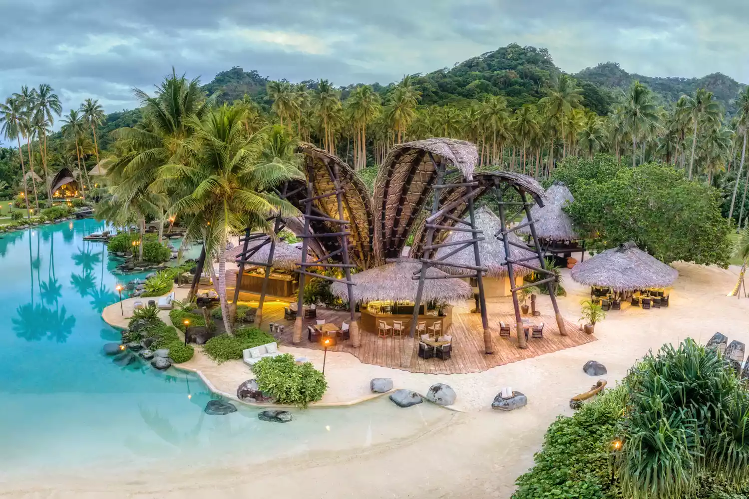 Aerial view of luxury villas and turquoise waters at COMO Laucala Island.