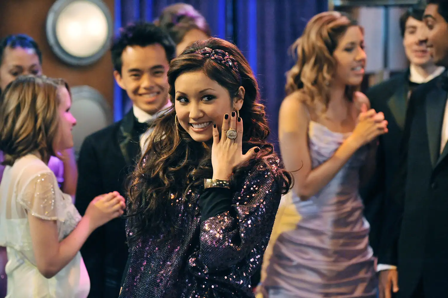 Brenda Song smiling warmly during a public appearance.