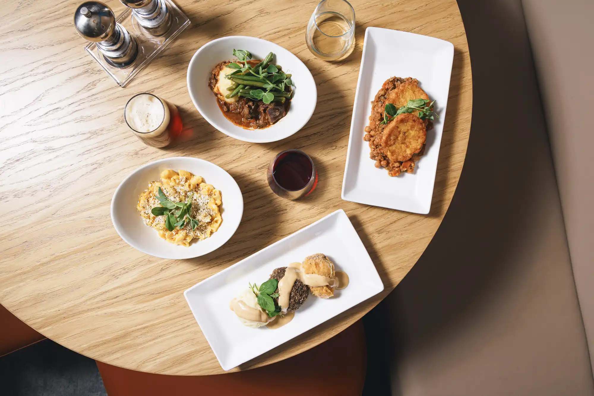 Selection of Scottish dishes and drinks served on a dining table inside the train's lounge car.