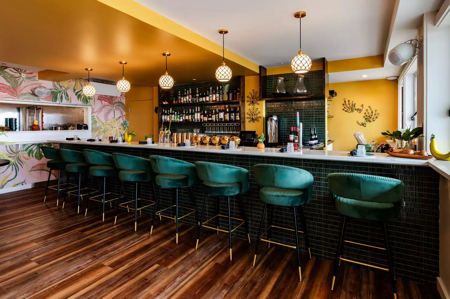 The interior bar area of Lulu's Tiki Bar and Restaurant with tropical-themed lighting and seating.