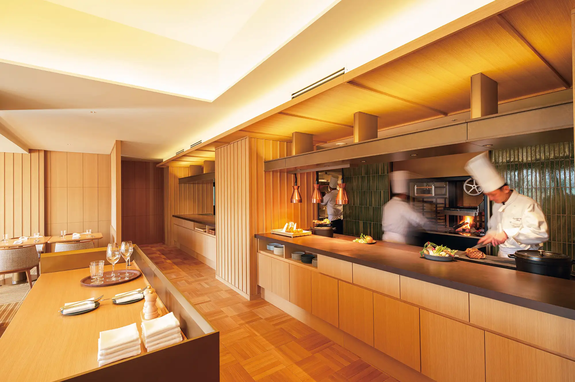 Professional chefs preparing food in a high-end open kitchen.