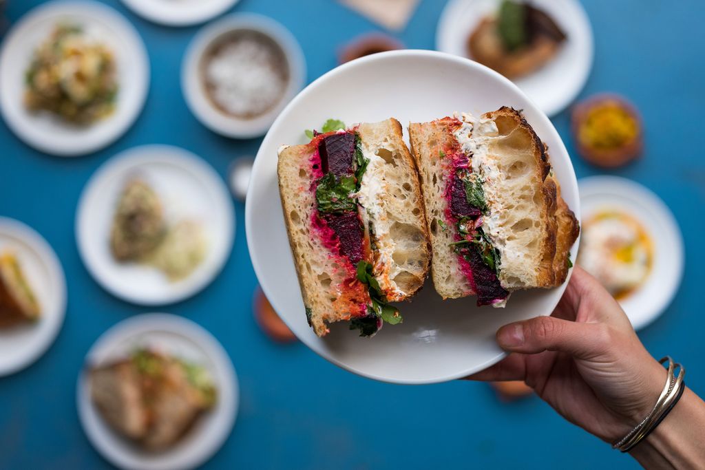 A sourdough sandwich with inventive fillings served on a plate at The Dusty Knuckle.