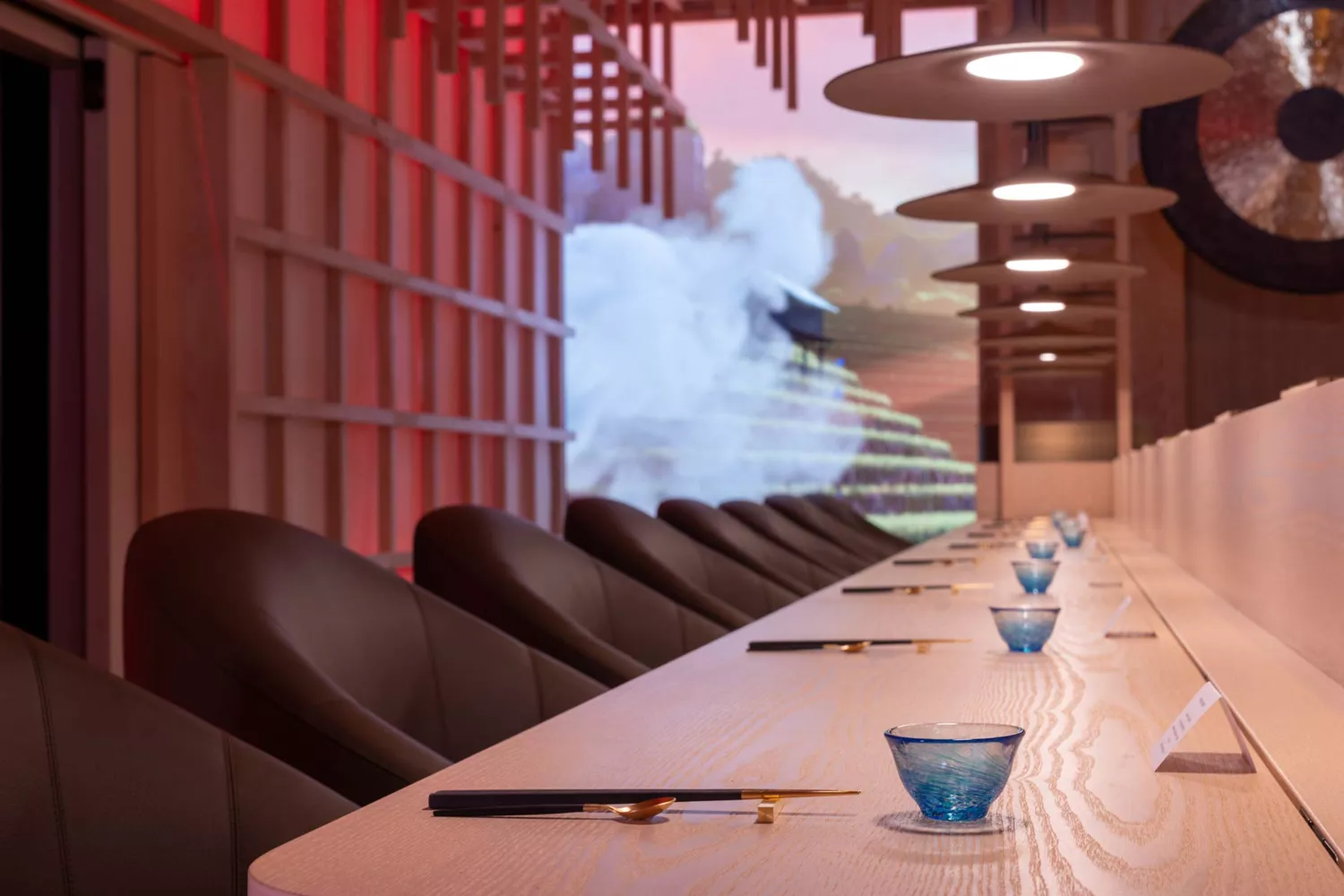 The atmospheric seating area within the Umami room at Eatrenalin featuring sleek counters and minimalist design.