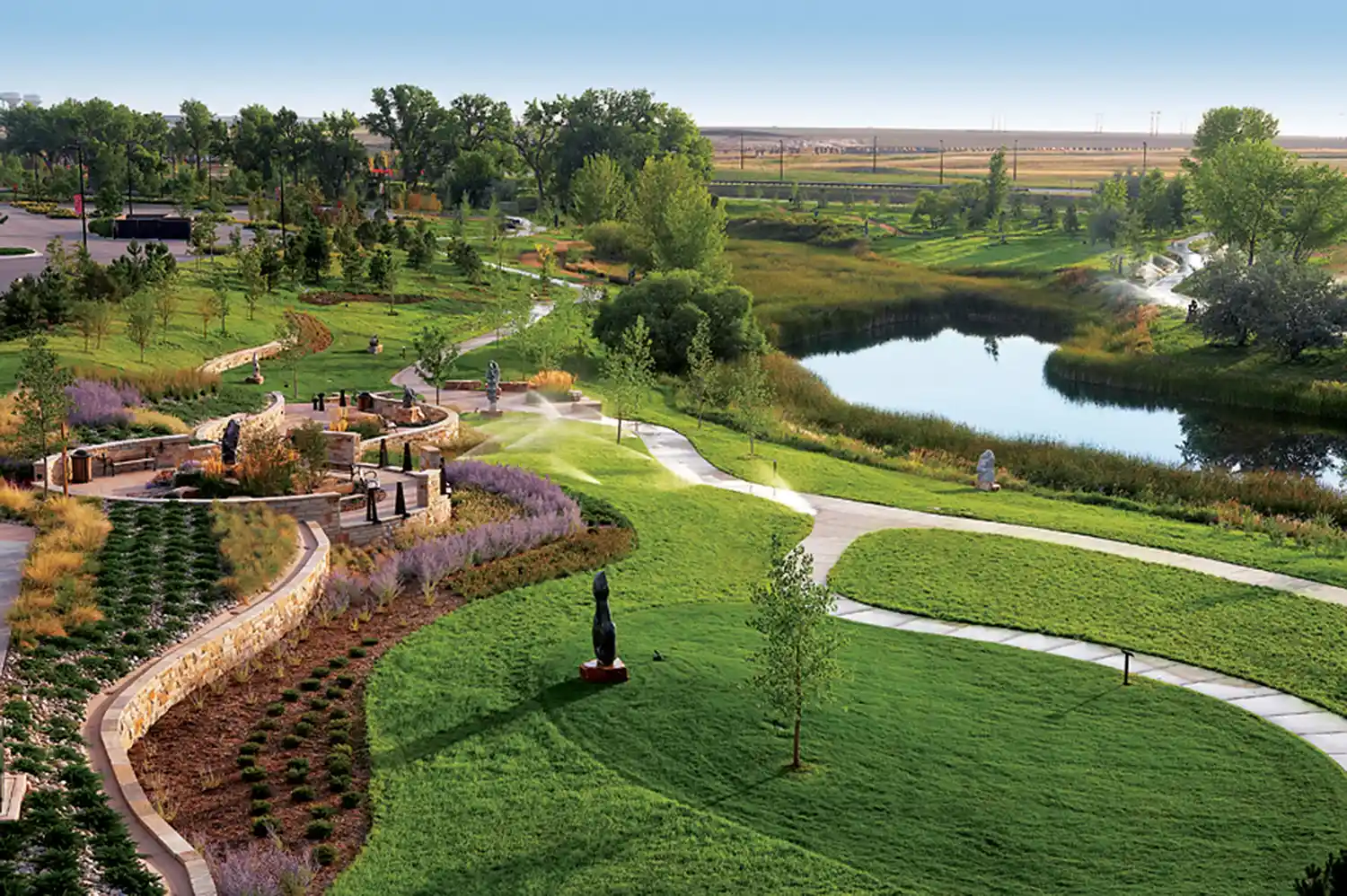 Aerial view of Chapungu Sculpture Park featuring winding walking paths, lush green spaces, and water features.