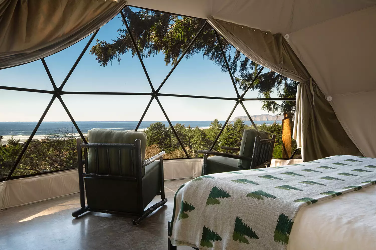 Interior of a geodesic dome at Two Capes Lookout featuring large windows overlooking the Pacific Ocean.