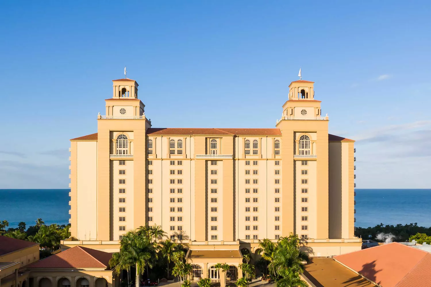 Modern building renderings showing the sleek exterior of the Ritz-Carlton Naples properties.