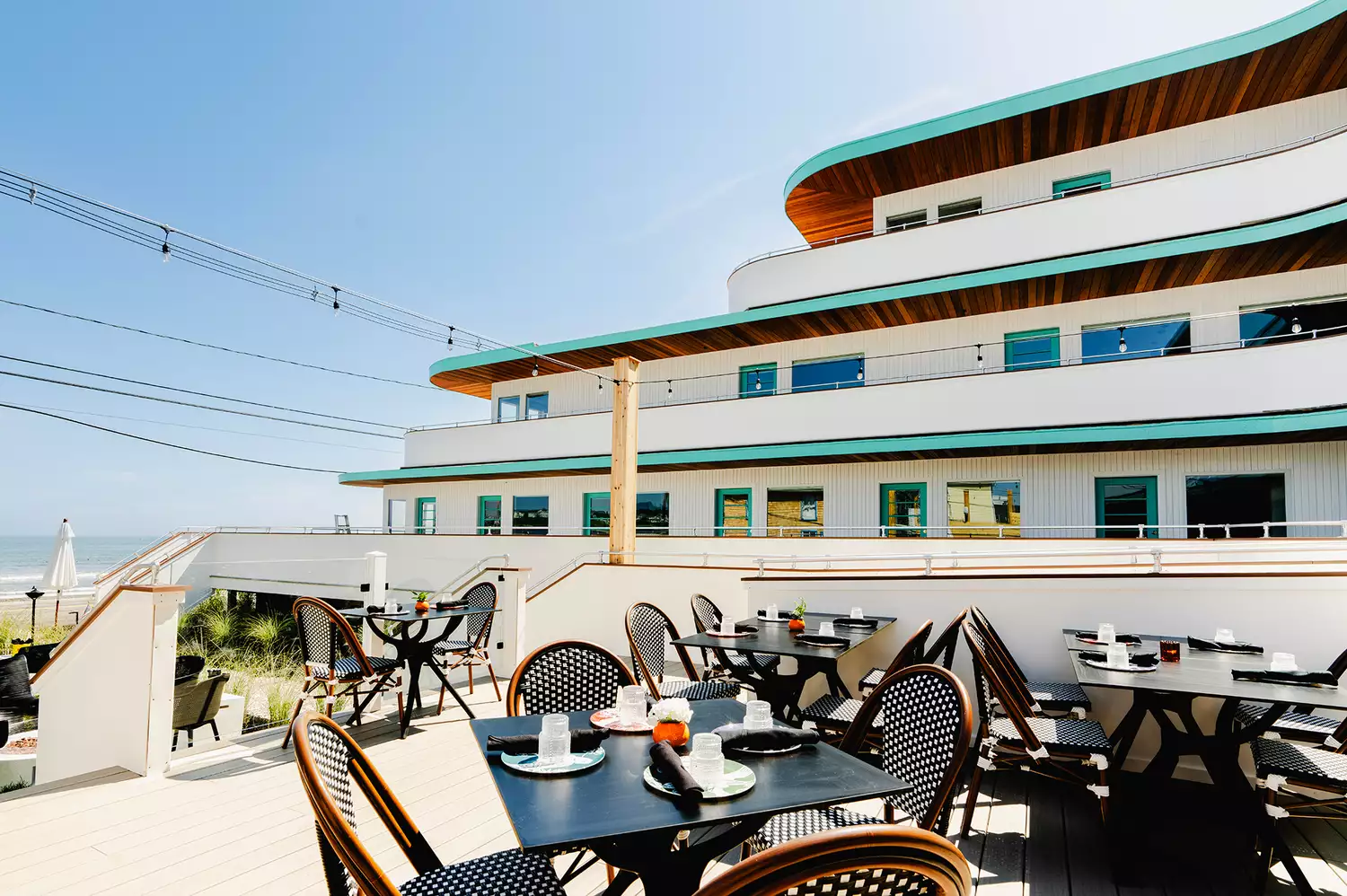 The outdoor dining deck of Lulu's Tiki Bar and Restaurant with patrons enjoying the coastal weather.