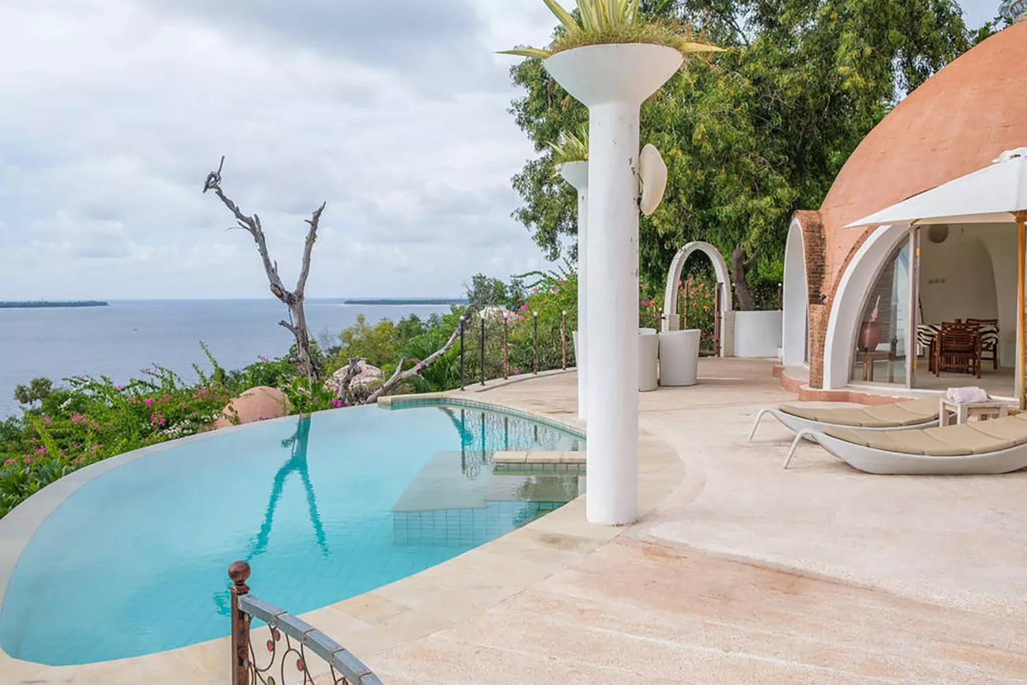 A luxury dome rental in Indonesia featuring a private swimming pool overlooking a tropical landscape.