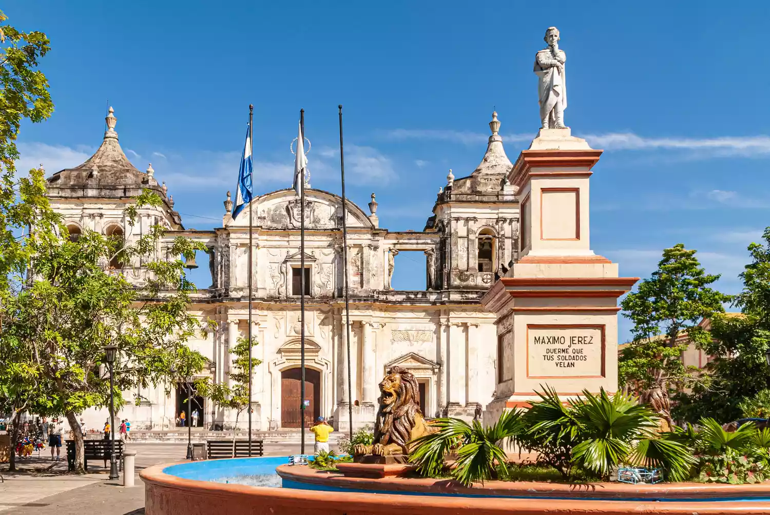 Historical statues and the ornate facade of the Cathedral of the Assumption in León, Nicaragua.
