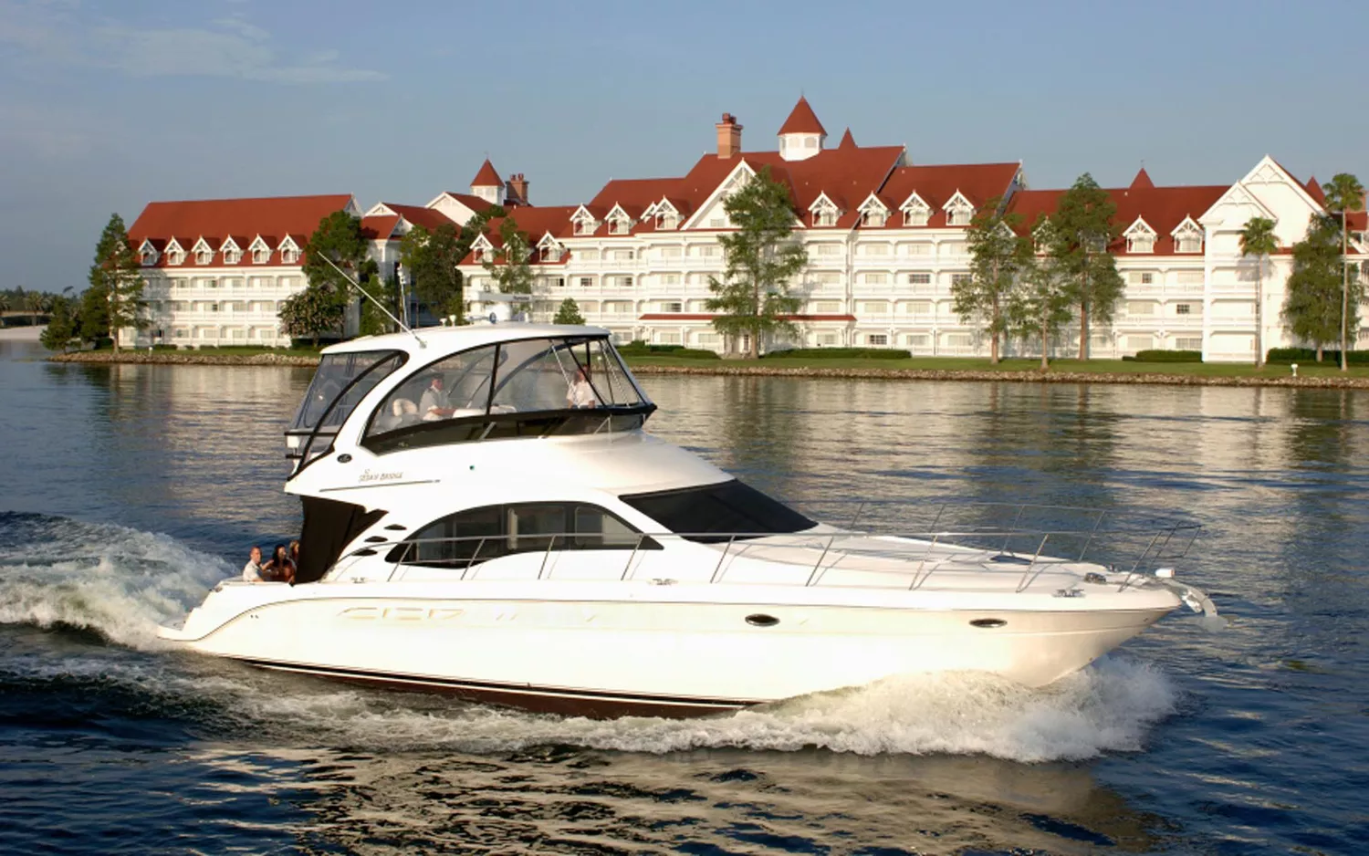 A white Disney ferry boat transports guests across the Seven Seas Lagoon.
