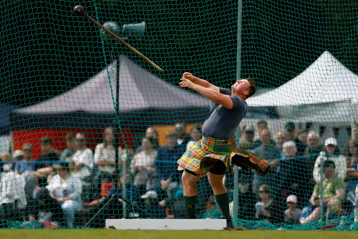 Athletes participating in a heavy event at the Highland Games.