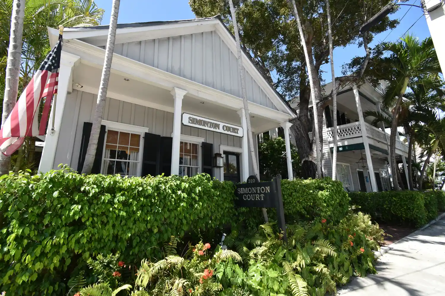 Simonton Court hotel building tucked behind dense tropical foliage in Key West.