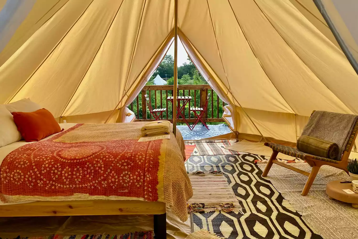 A luxury bell tent at Gatherwild with a simple, rustic-chic outdoor setup.