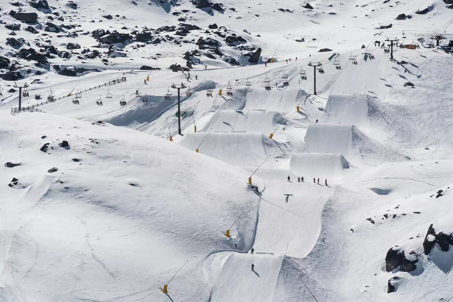 Skiers on the slopes of The Remarkables ski resort overlooking the valley