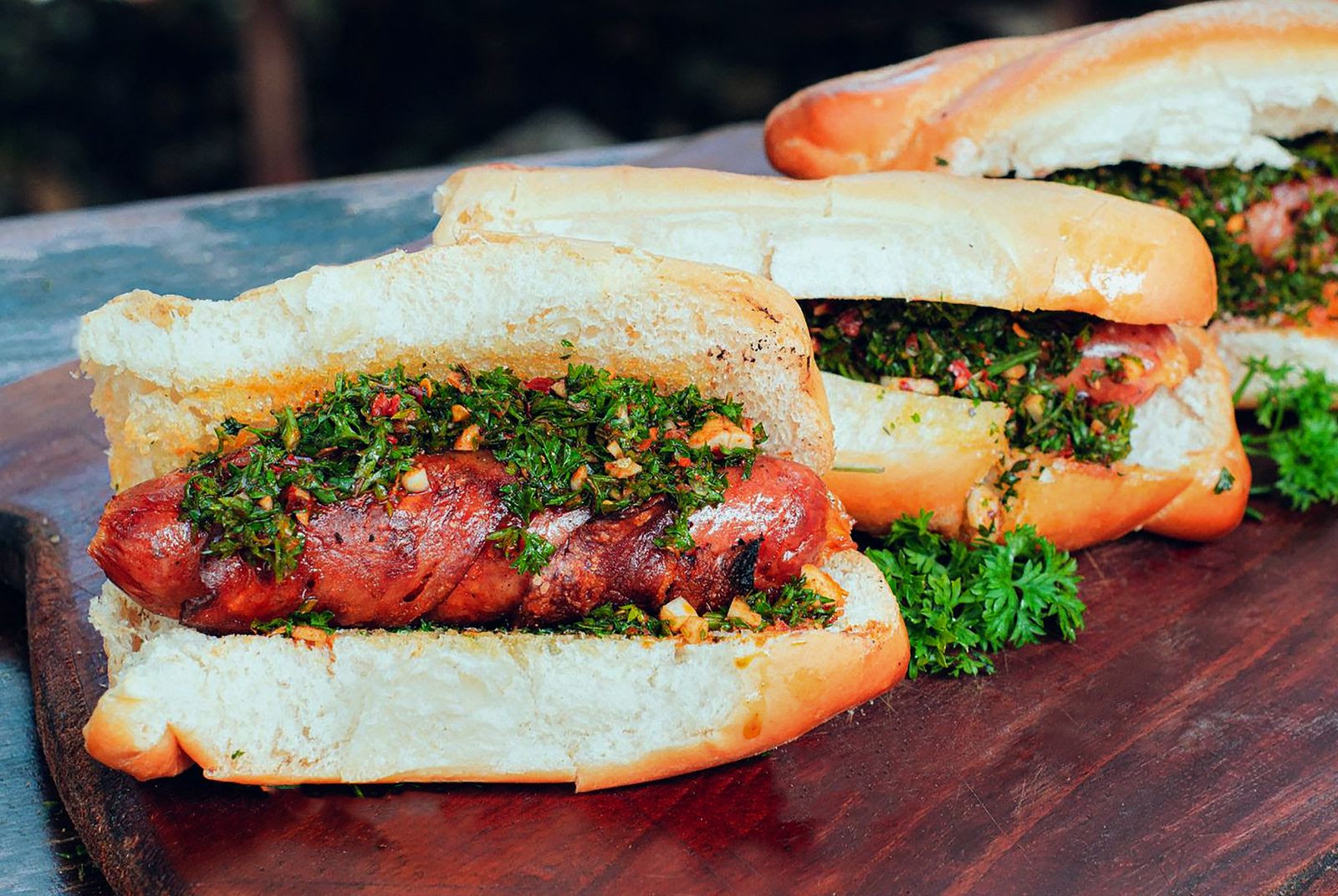 Close-up of a traditional choripán or meat sandwich served at a street food stand.
