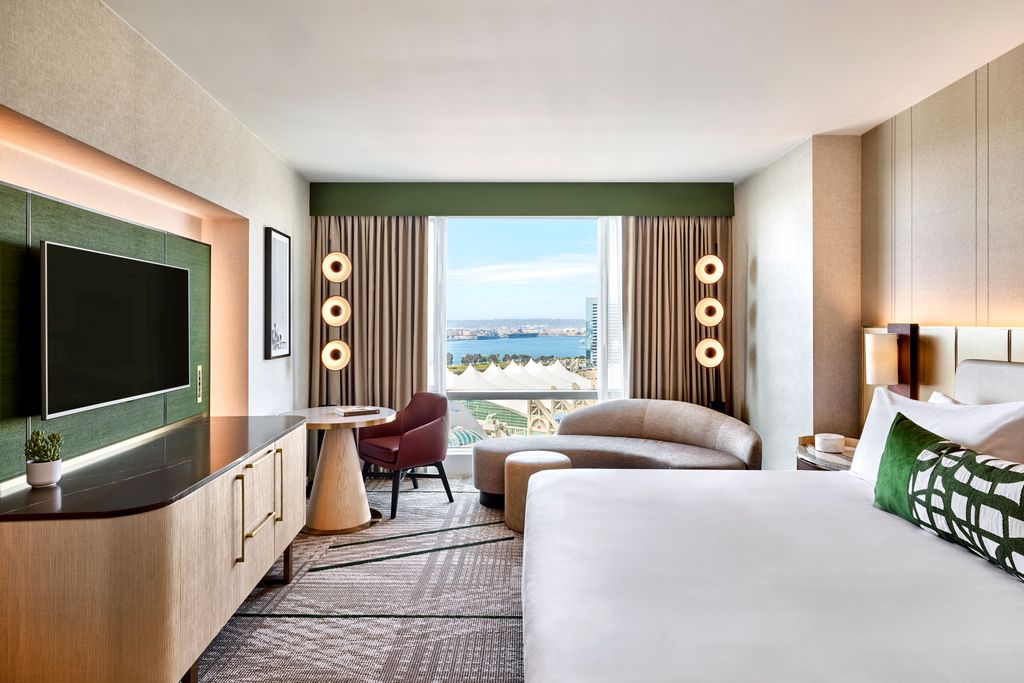 Luxury corner suite interior in San Diego with floor-to-ceiling windows overlooking Petco Park.