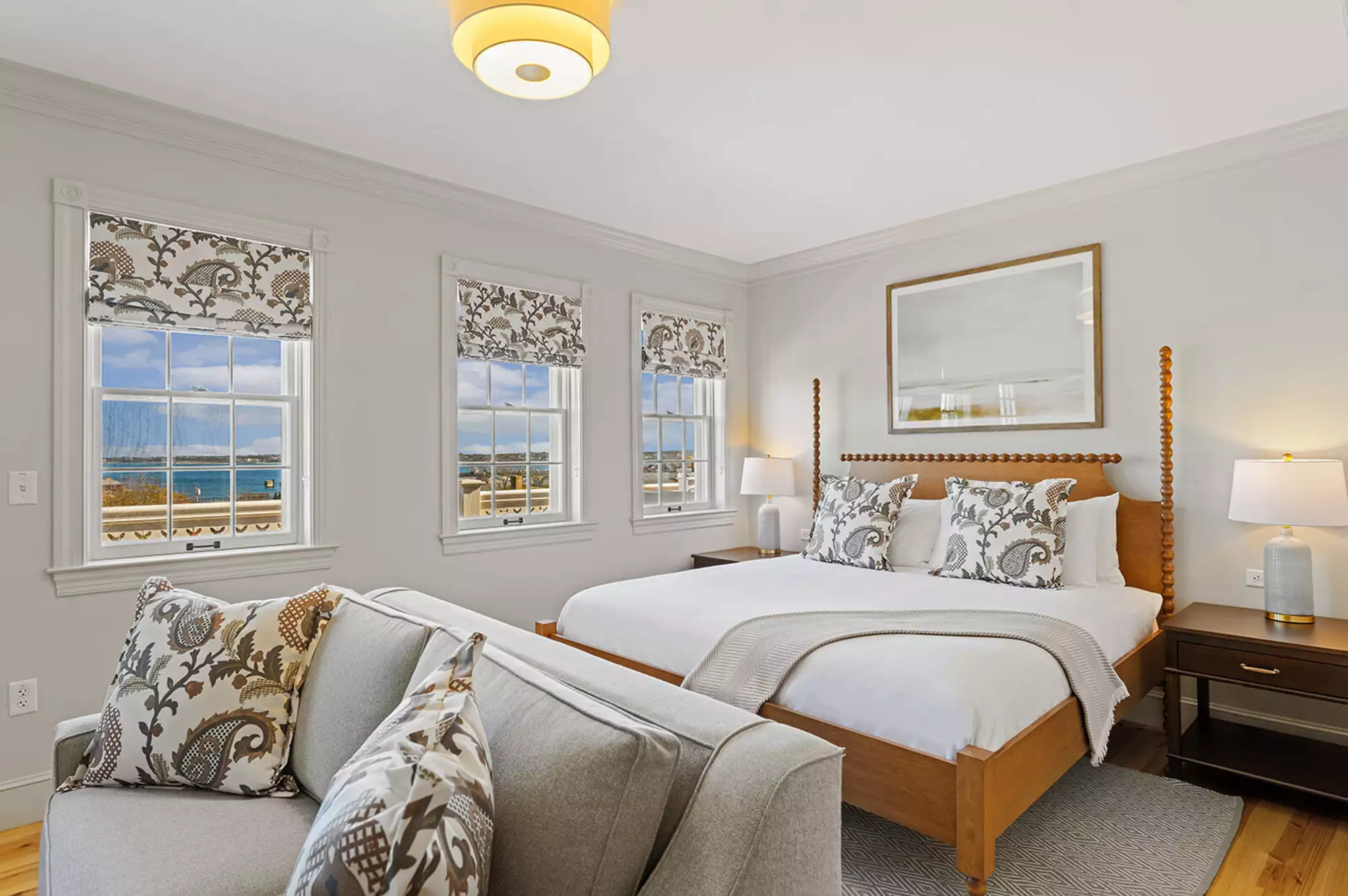 A luxury guest room at Veranda House featuring Matouk linens and modern coastal decor.