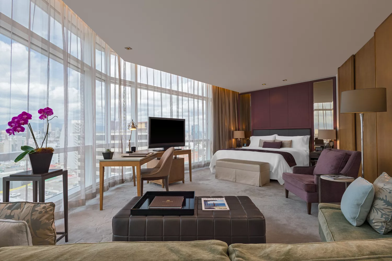 Luxury suite interior at The St. Regis Mexico City with large windows overlooking the city skyline.