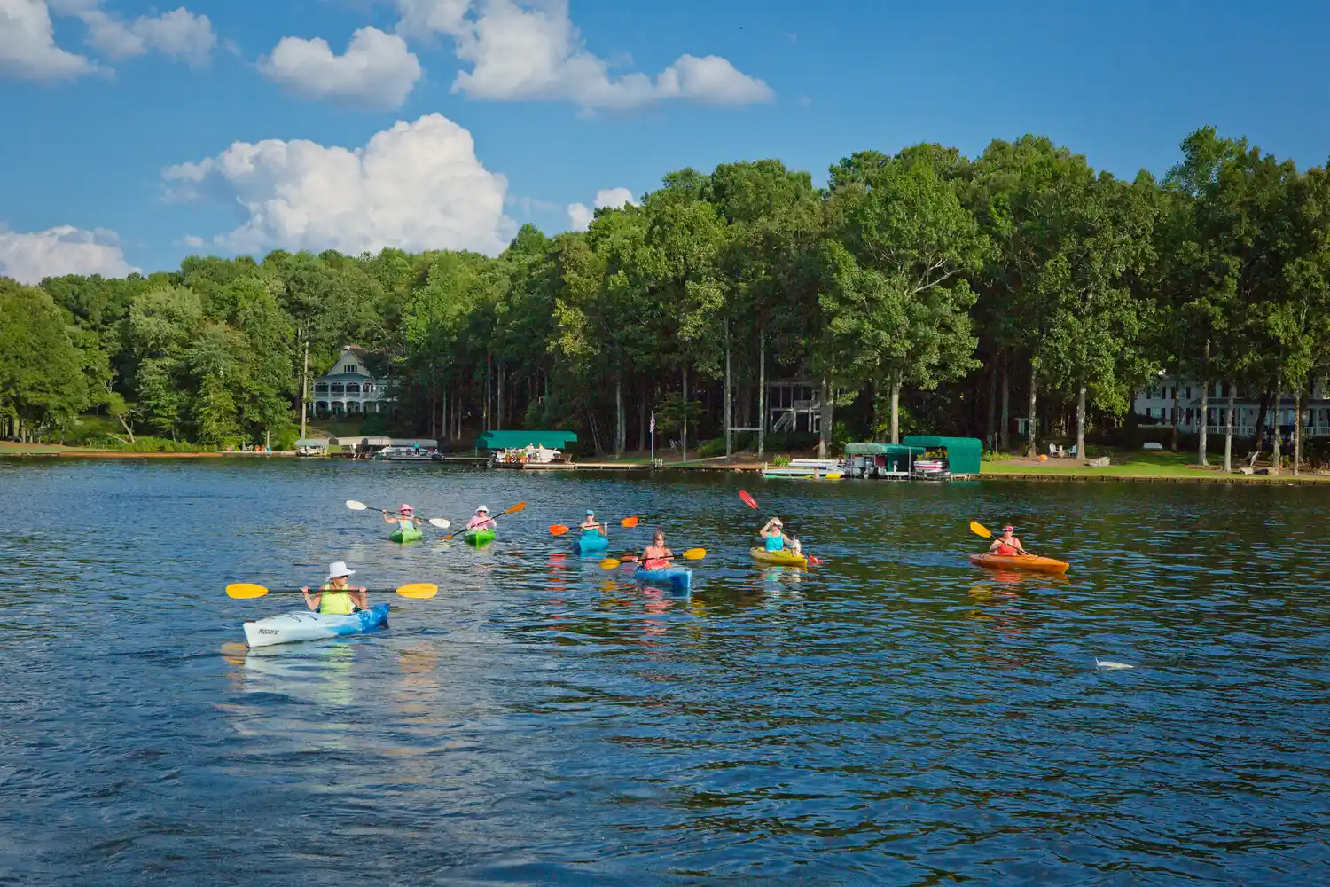 Two people in kayaks paddling on the calm water of Lake Oconee near Greensboro, Georgia.