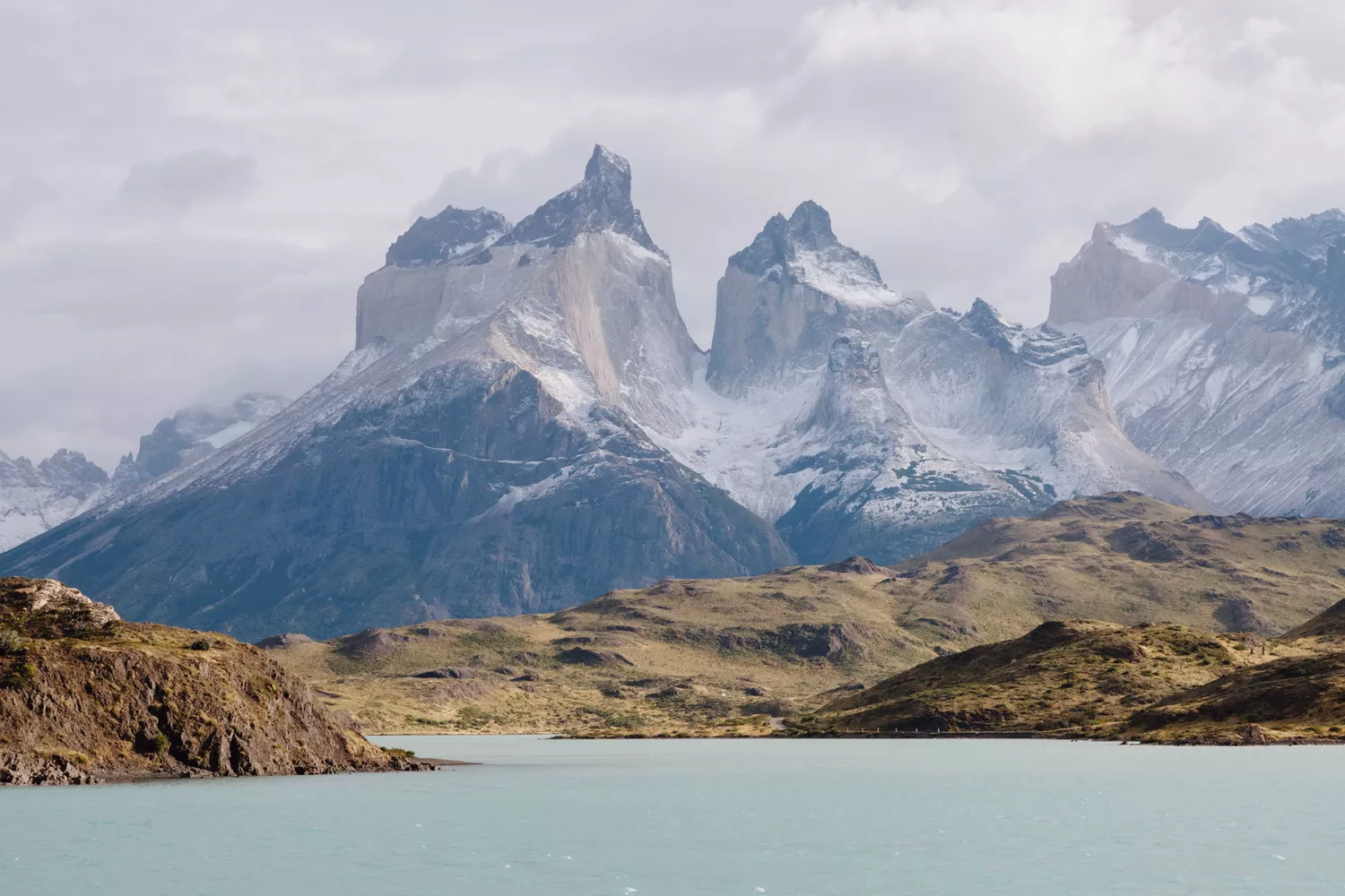 The granite towers of Torres del Paine reflecting in a calm lake in Chilean Patagonia.