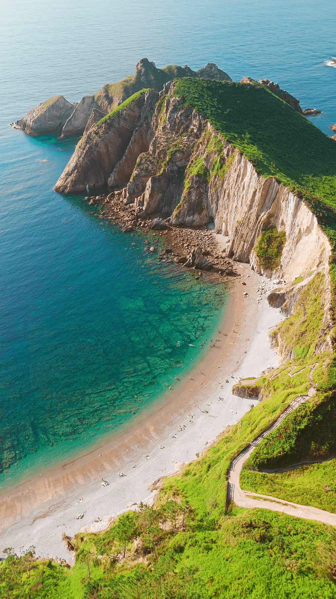 Dramatic rocky promontory overlooking the deep blue sea at the Asturian coast.