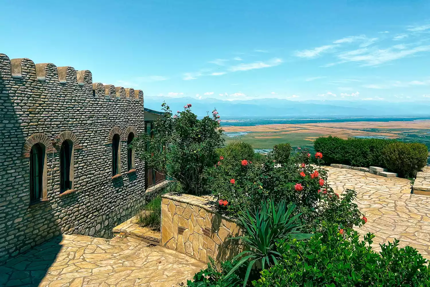 The red-tiled roofs and stone towers of the historic town of Sighnaghi overlooking the Alazani Valley.