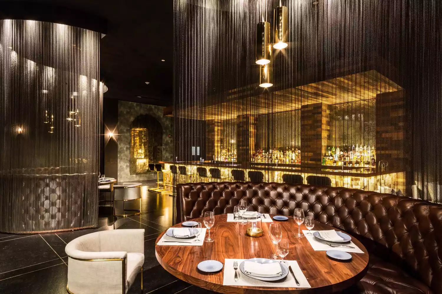 Interior of a modern, upscale restaurant at Grand Velas Los Cabos with elegant table settings.