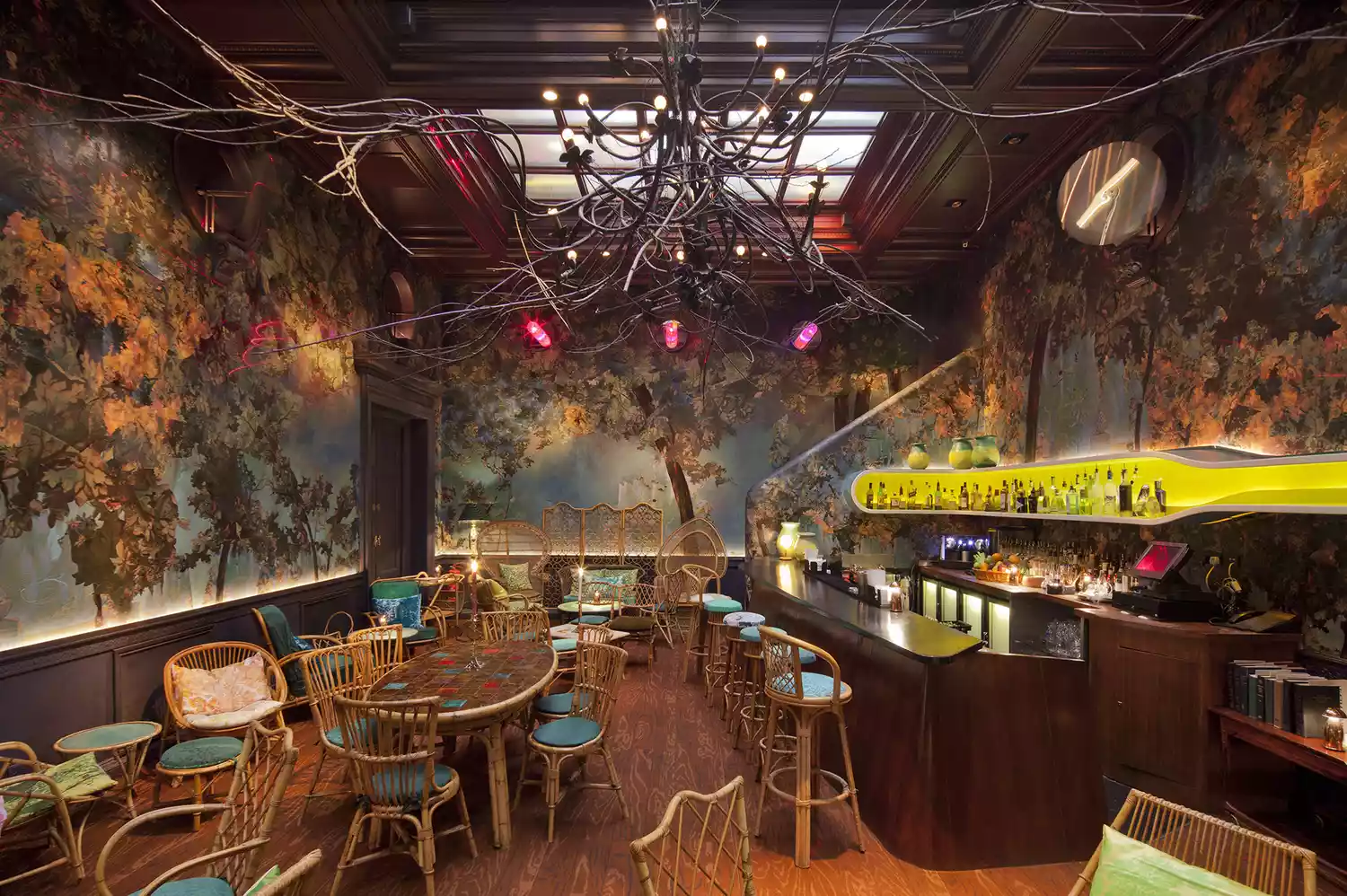 The Glade Bar at Sketch featuring woodland-themed wallpaper and forest-inspired decor.
