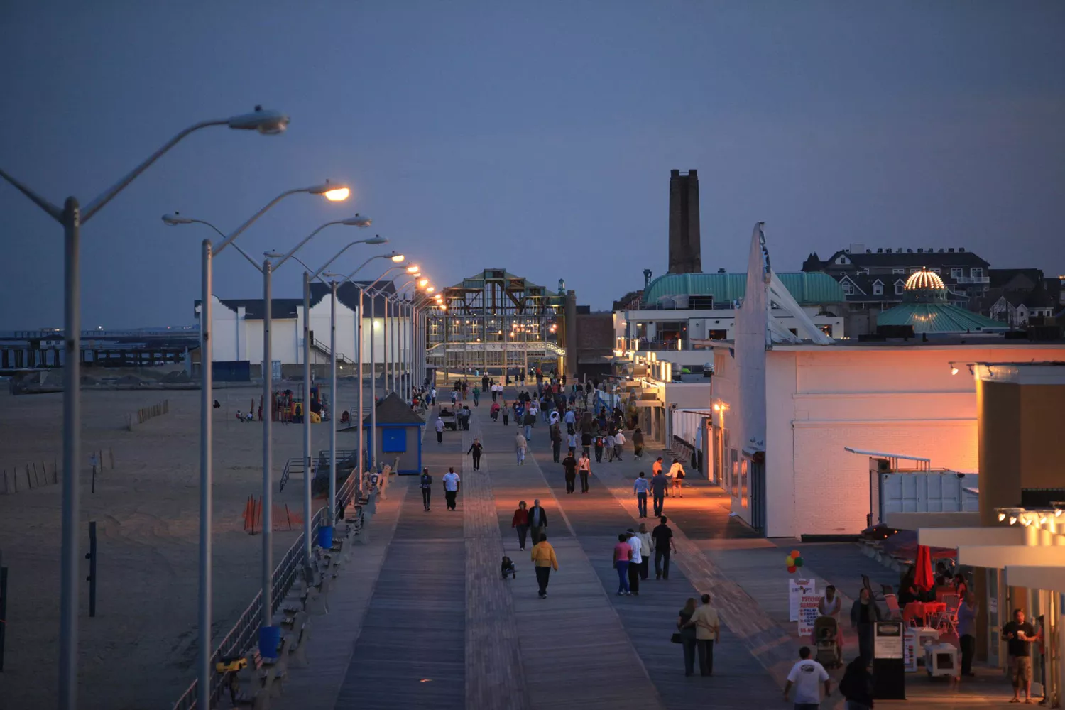 The historic Casino at the end of the Asbury Park boardwalk lit up against the night sky.