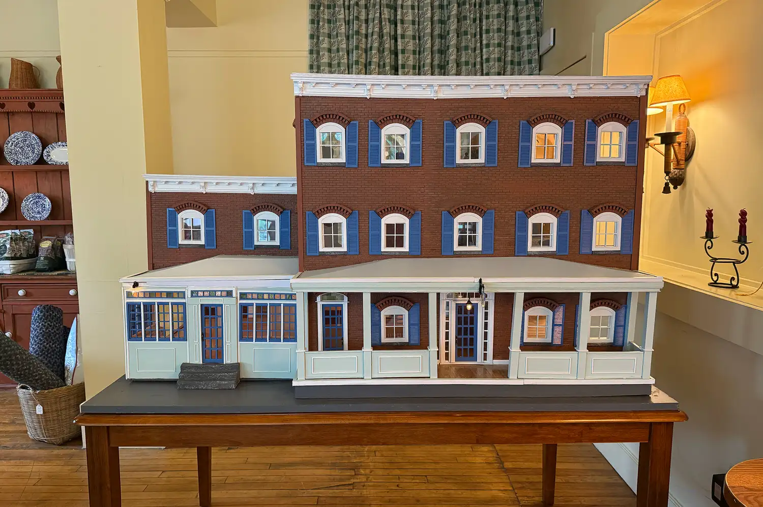 A detailed architectural dollhouse model of The Six Bells Countryside Inn on a wooden table.