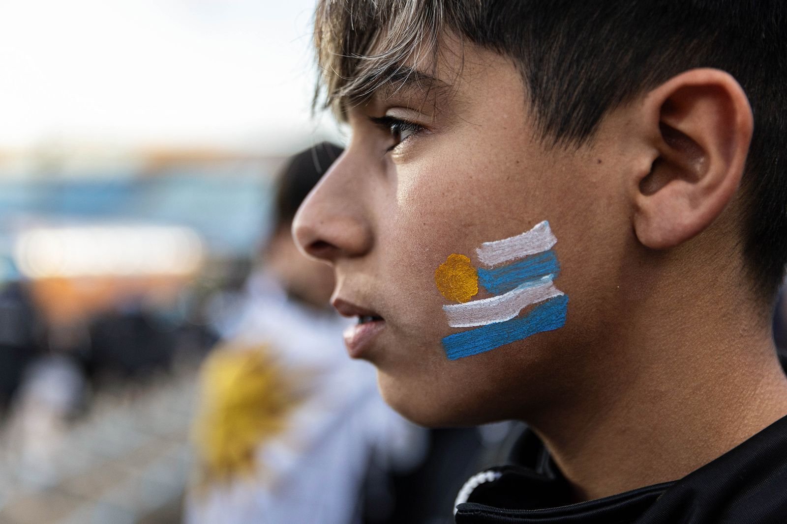 Close-up portrait of a local supporter reflecting the passion of Uruguayan football fans.