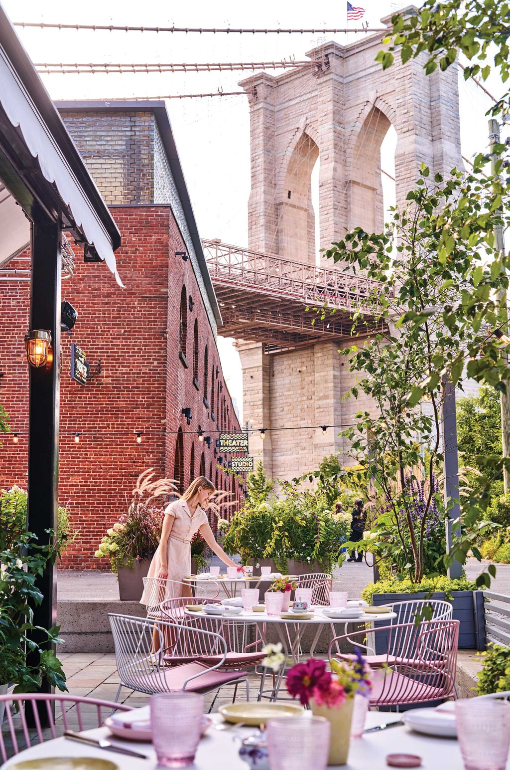 Outdoor terrace at ABC Kitchens BK with a clear view of the Manhattan Bridge and East River.