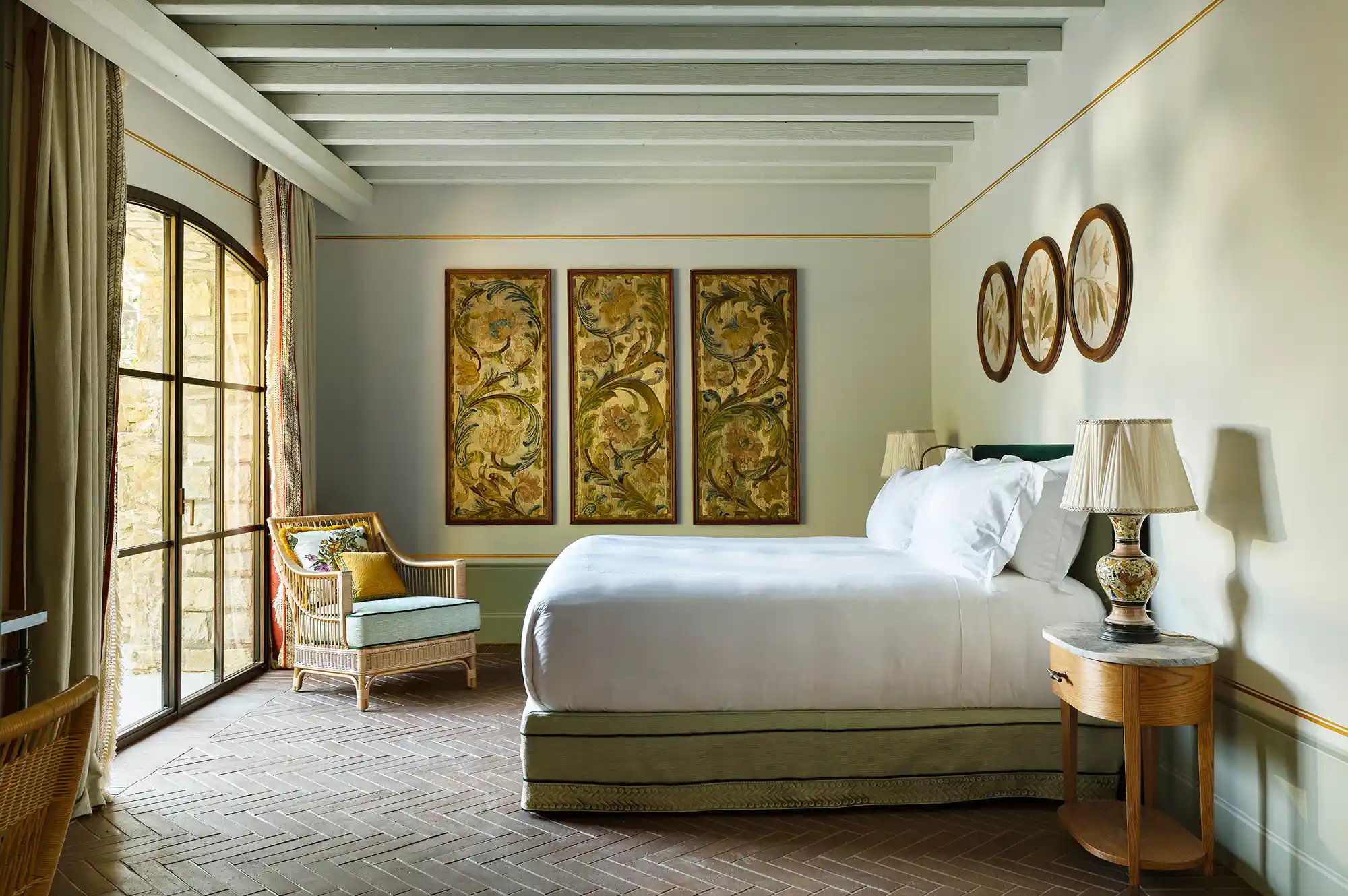 A luxurious bedroom suite with elegant wall art and direct terrace access.