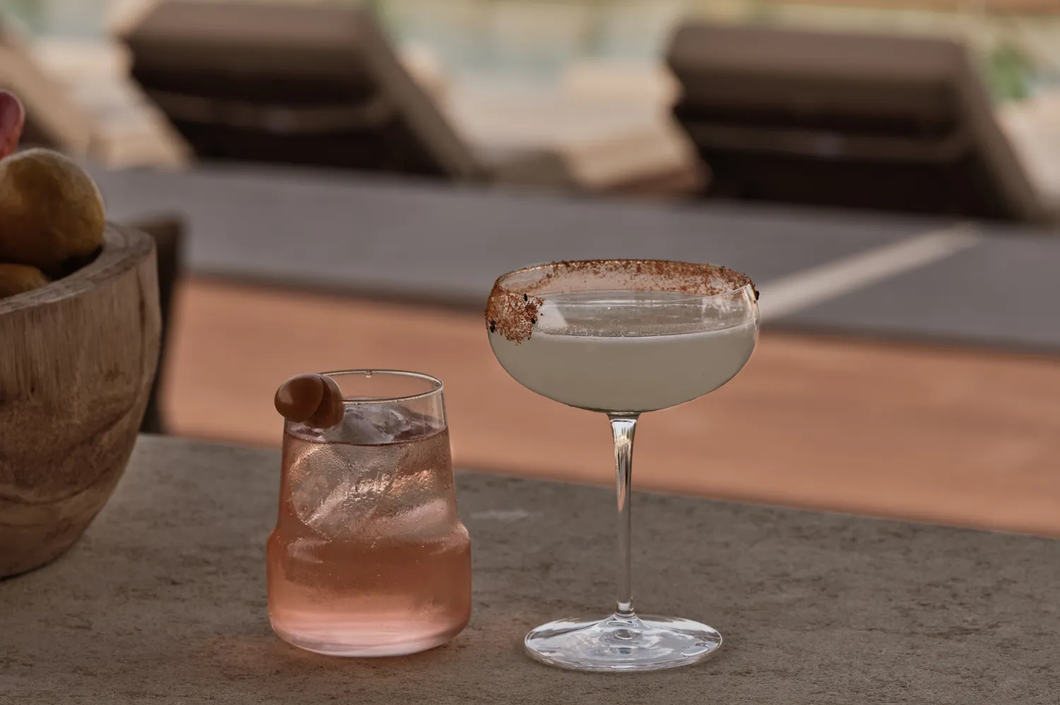 Two craft cocktails on a table at the Oku Andalusia main bar.