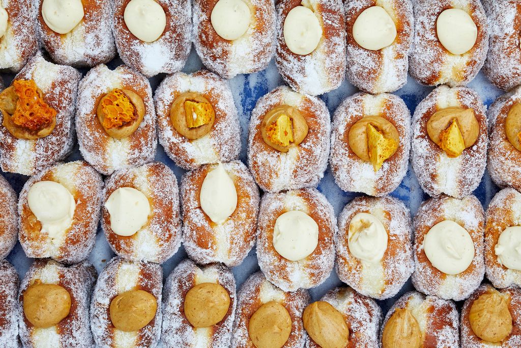 A selection of cream-filled doughnuts and cinnamon rolls at Bread Ahead.