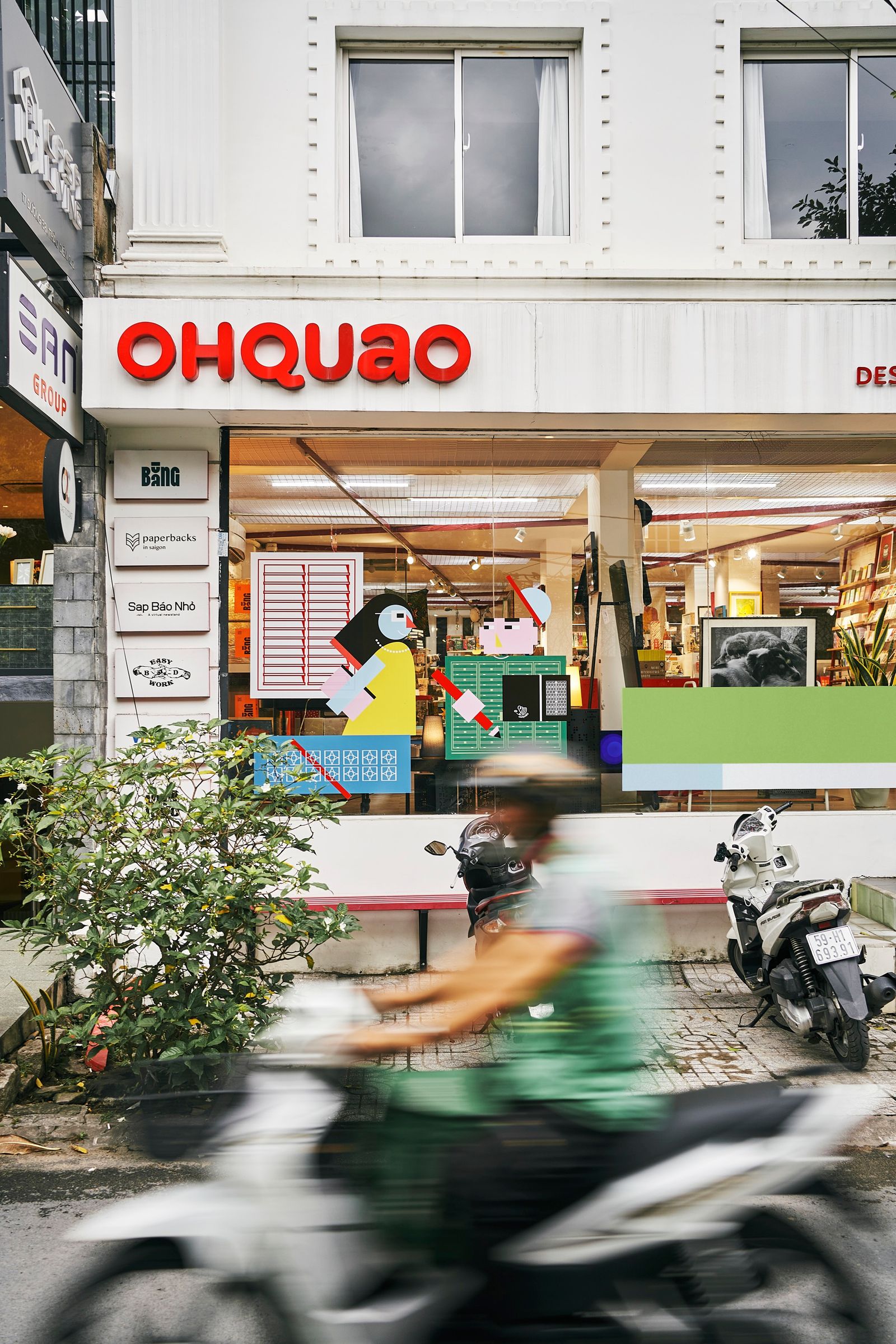 A street view of Thao Dien ward with motorcycles and boutique shop fronts.