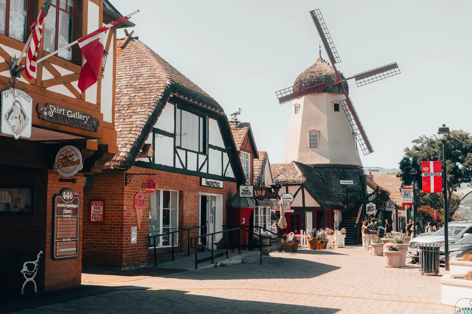 Downtown Solvang featuring Danish-style buildings and a prominent wooden windmill.