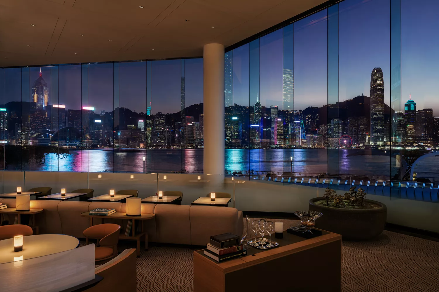 The contemporary lounge at Regent Hong Kong featuring floor-to-ceiling windows overlooking Victoria Harbour.